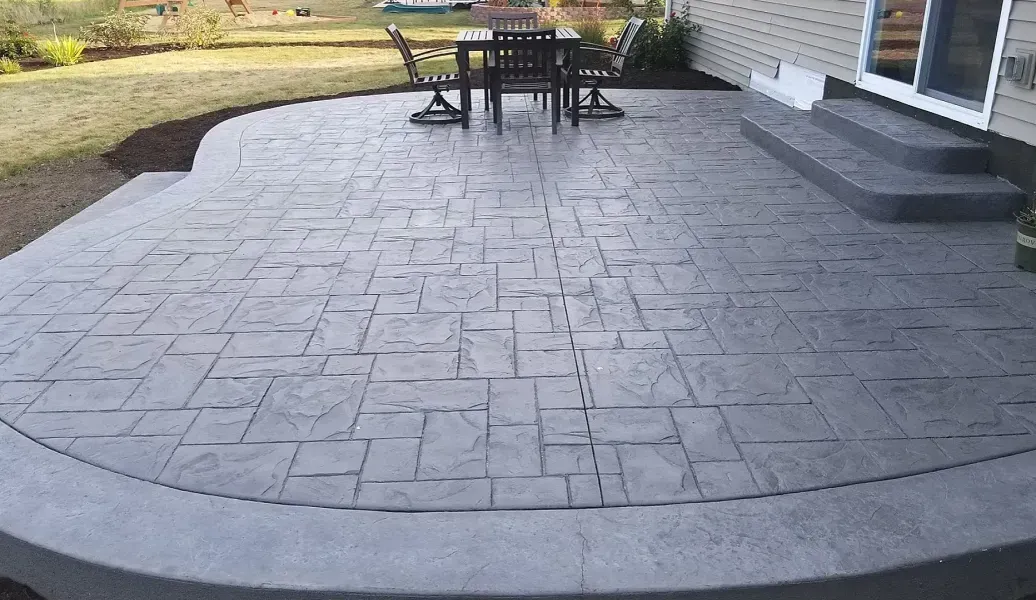 Patio with brick pavers, fire pit, and swimming pool.