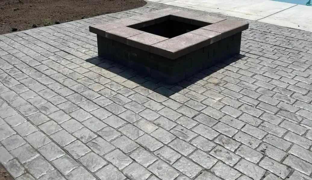 Brown rectangular pavers arranged in a repeating pattern.
