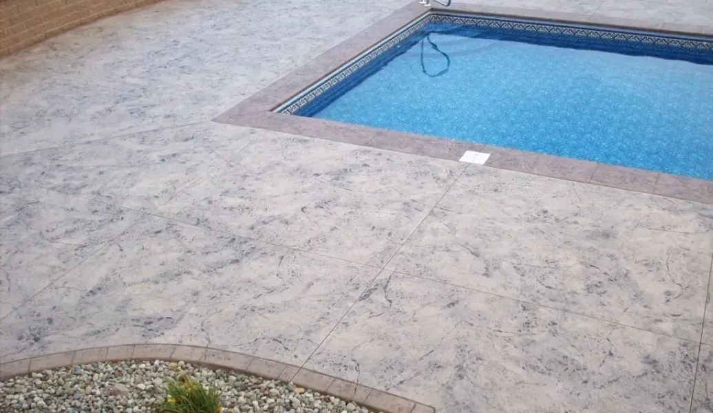 Square brown tiles laid out, with dark, wet patches.