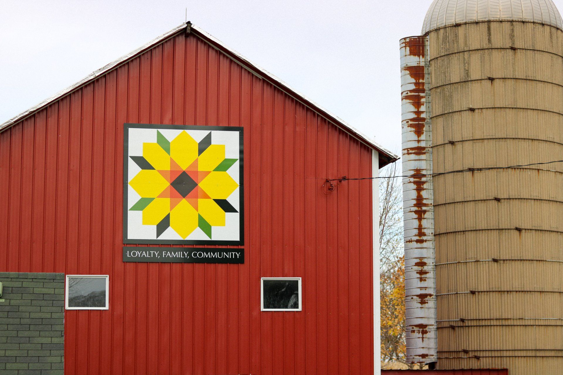 A red barn with a quilt pattern on it