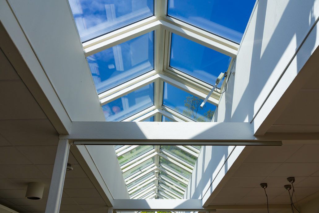 Door een lichtstraat in een gebouw naar de hemel kijken