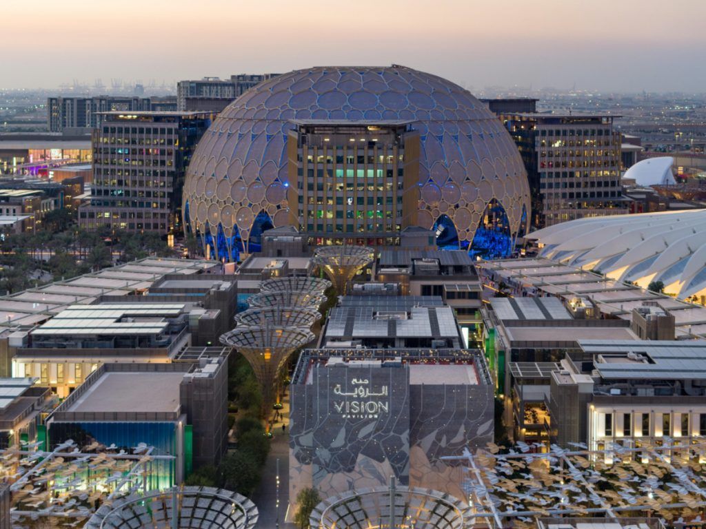 An aerial view of a city with a large dome in the middle of it.