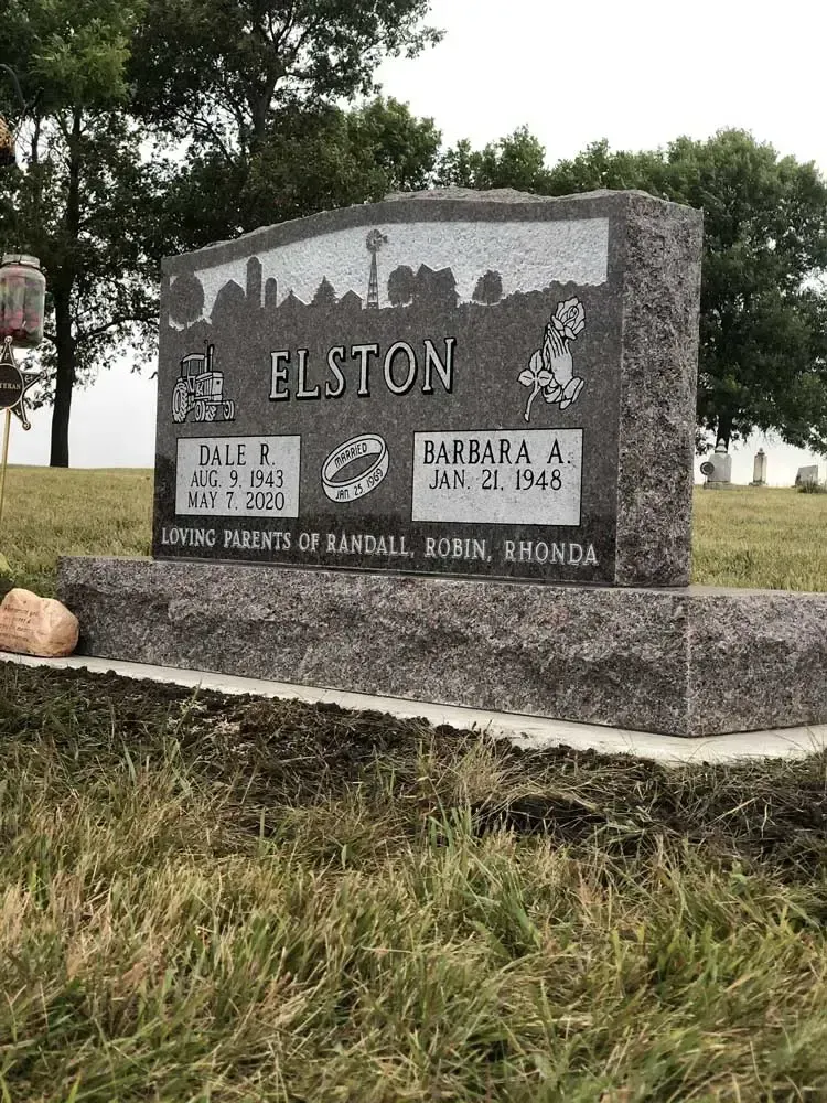 Granite memorial for Elston family in a grassy cemetery, with engraved names and dates.