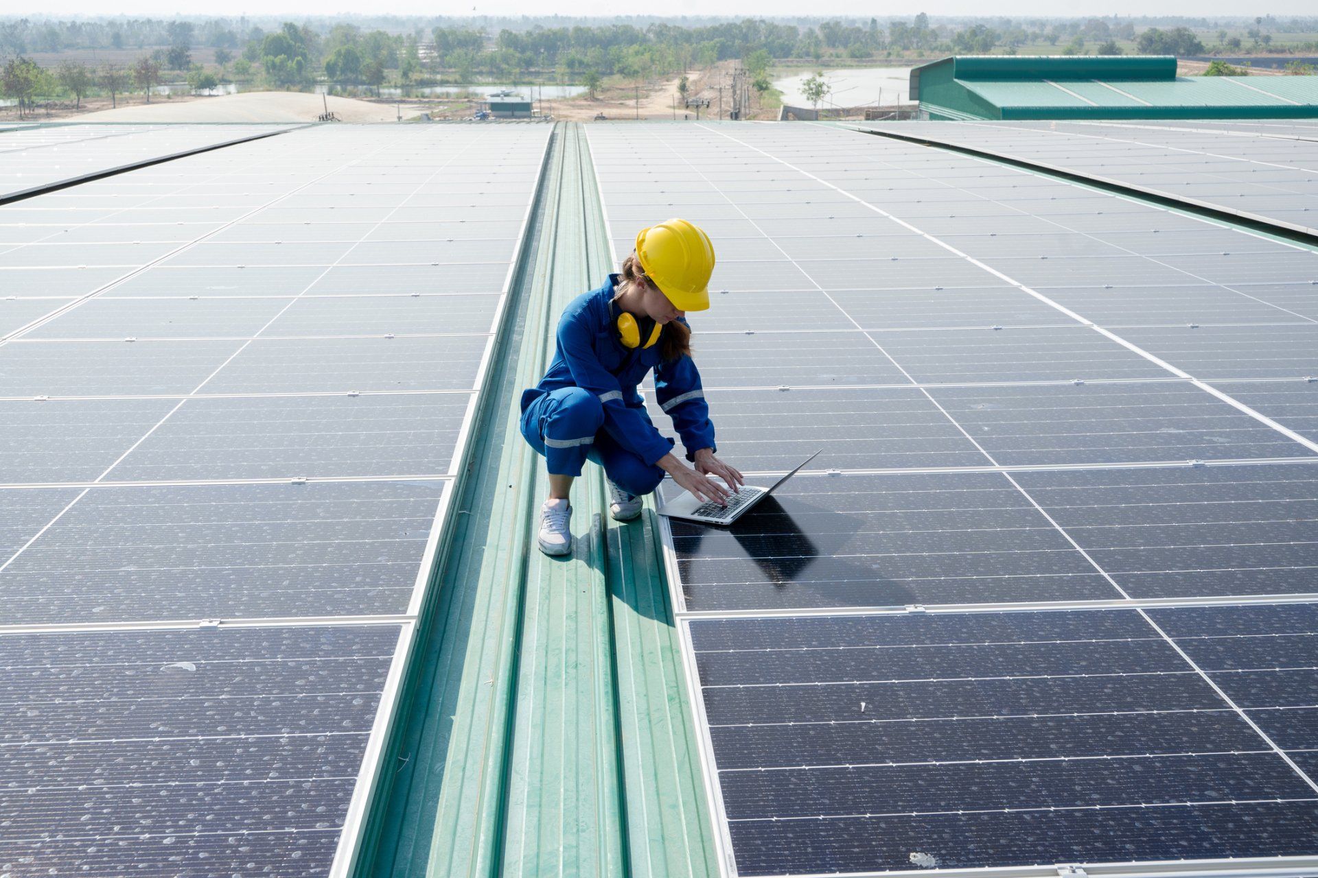 A Person with Yellow Hard Hat with Loptop on the Roof – Brisbane, QLD – Star Bright Energy