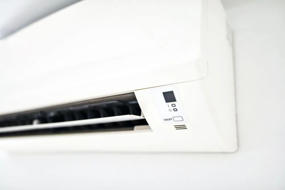 White Air Conditioner Mounted on a White Wall — Climate King In Orange, NSW