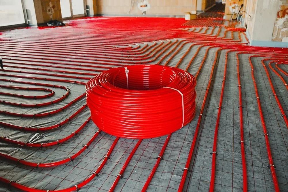 Red Radiant Heating Pipes Laid Out on a Gray Floor — Climate King In Orange, NSW
