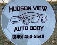 A circular sign for Hudson View Auto Body with a car outline and phone number (845) 454-5540, set against a soccer ball print.