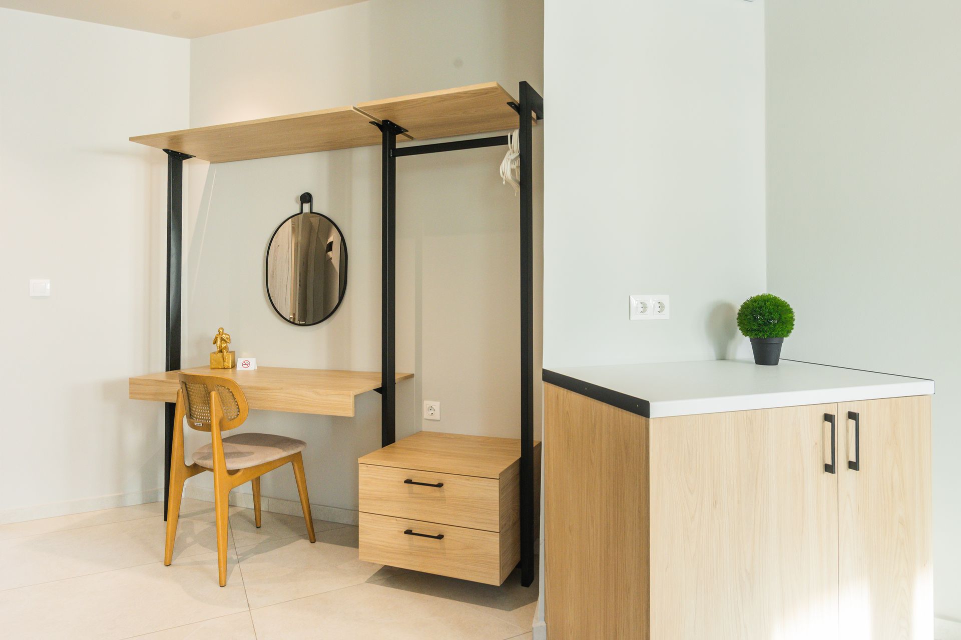 Modern room interior with wooden desk, closet, and small cabinet.