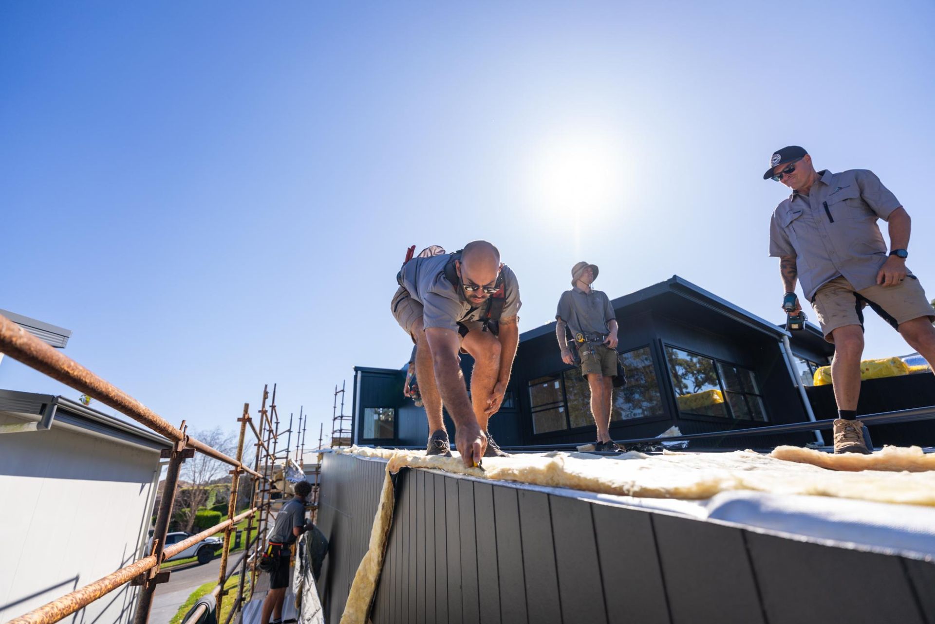 A Group of Construction Workers are Working on the House Roof — Roofing Contractor in Wauchope, NSW
