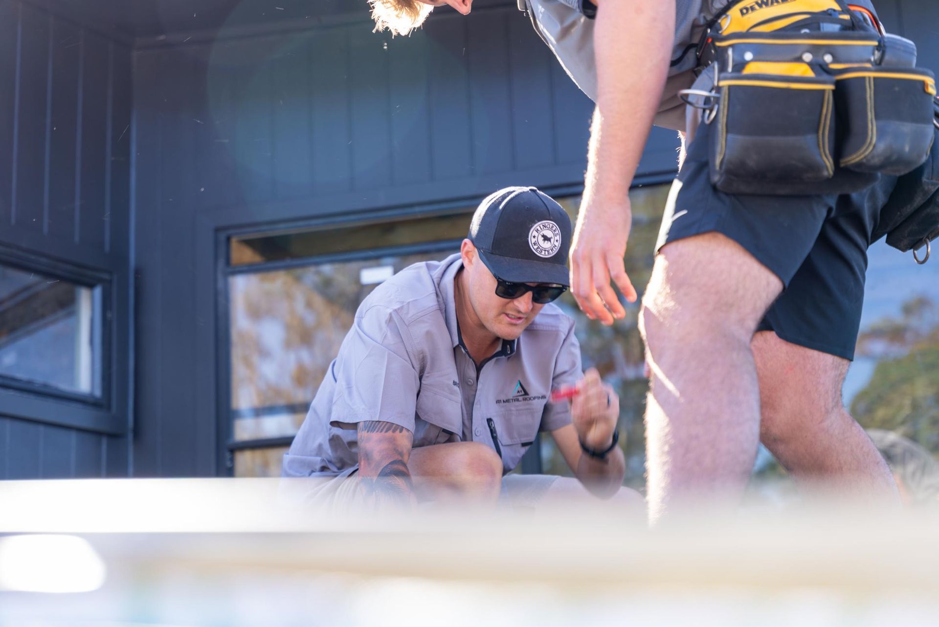 Two Workers are Working on the House Roof — Roofing Contractor in Port Macquarie, NSW