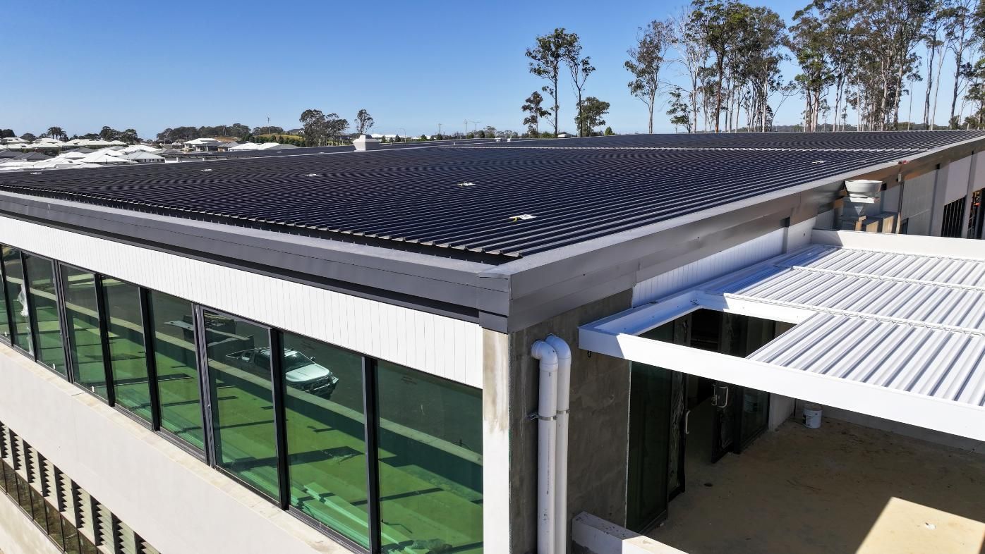 Modern Design of a Building With Solar Panel on the Roof — Roofing Contractor in Wauchope, NSW