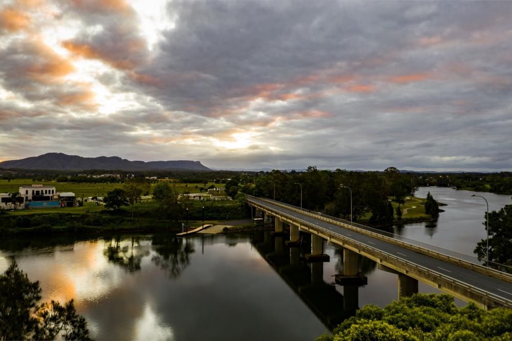 An Aerial View of a Bridge Over a River and Sunset — Roofing Contractor in Wauchope, NSW