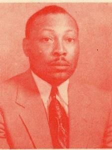 Formal portrait of a man in a suit and tie, tinted red against a plain background