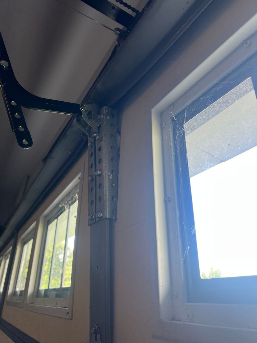 Garage door technician repairing torsion spring