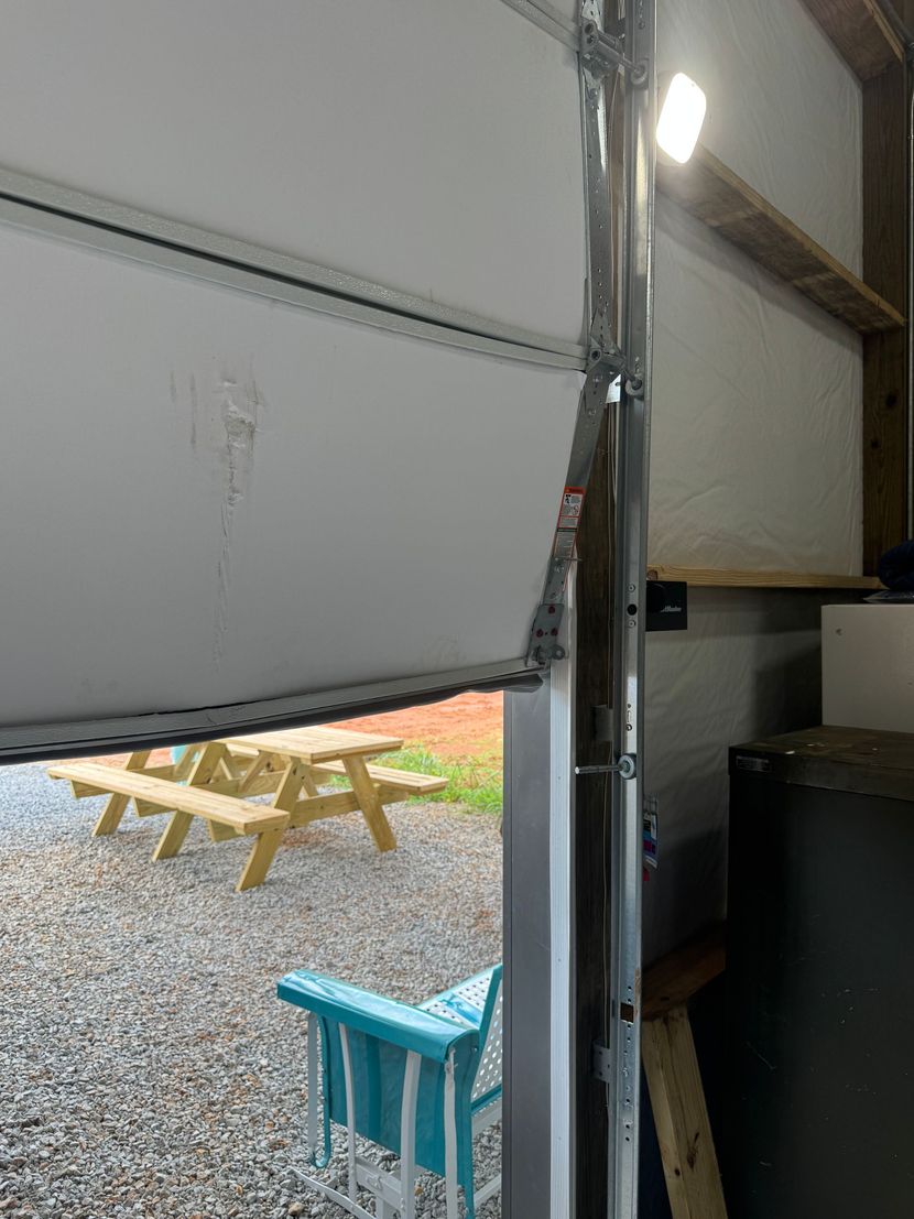New garage door being installed on a suburban home