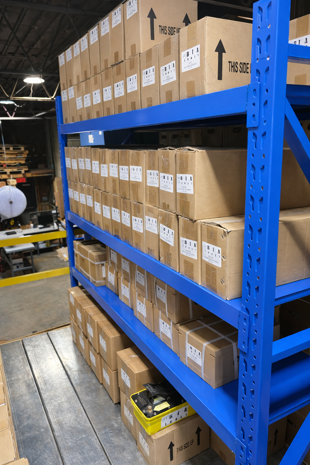 Blue industrial metal shelving units filled with rows of identical cardboard boxes in a warehouse setting.