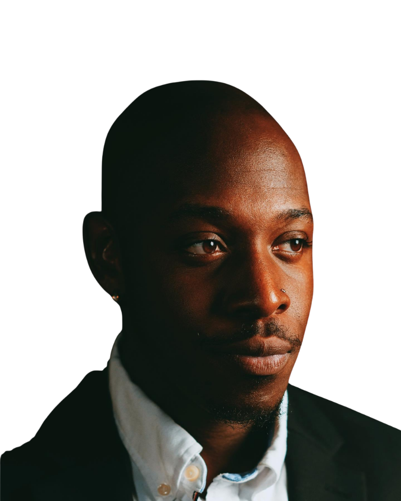 Portrait of DJ Milly in a dark suit and white shirt.