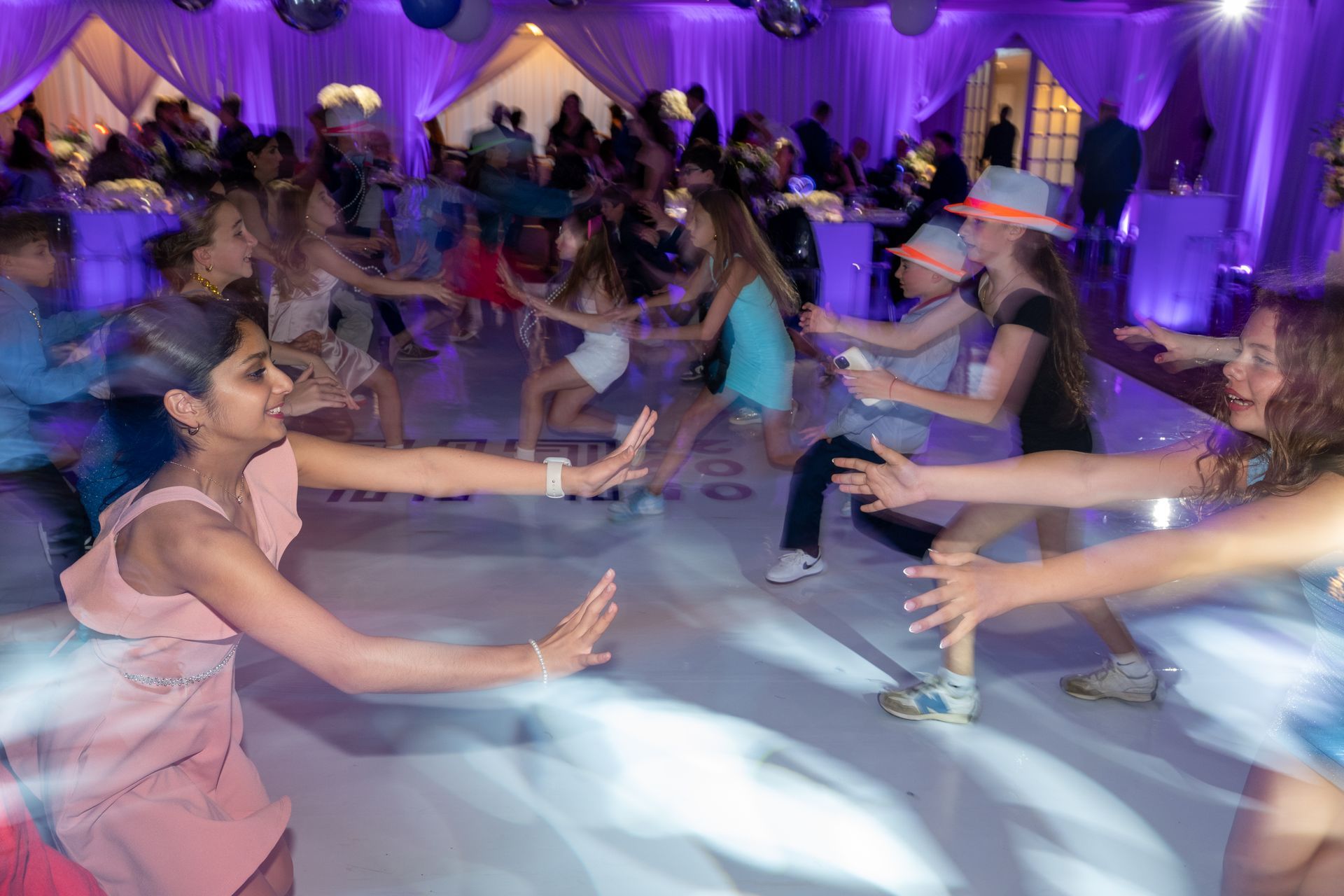 Kids celebrating and dancing at a Bat Mitzvah at Radnor Valley Country Club.