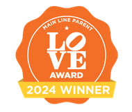 A orange ribbon for the 2024 Main Line Parent Love Award Winner Empower Event Group.
