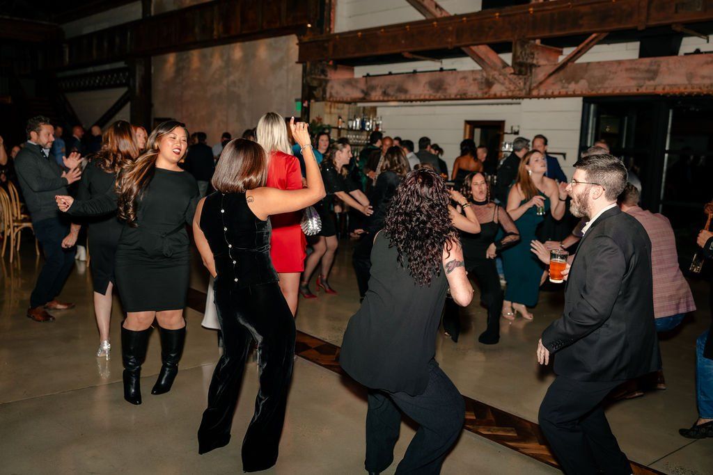 Coworkers dancing at a corporate holiday party.