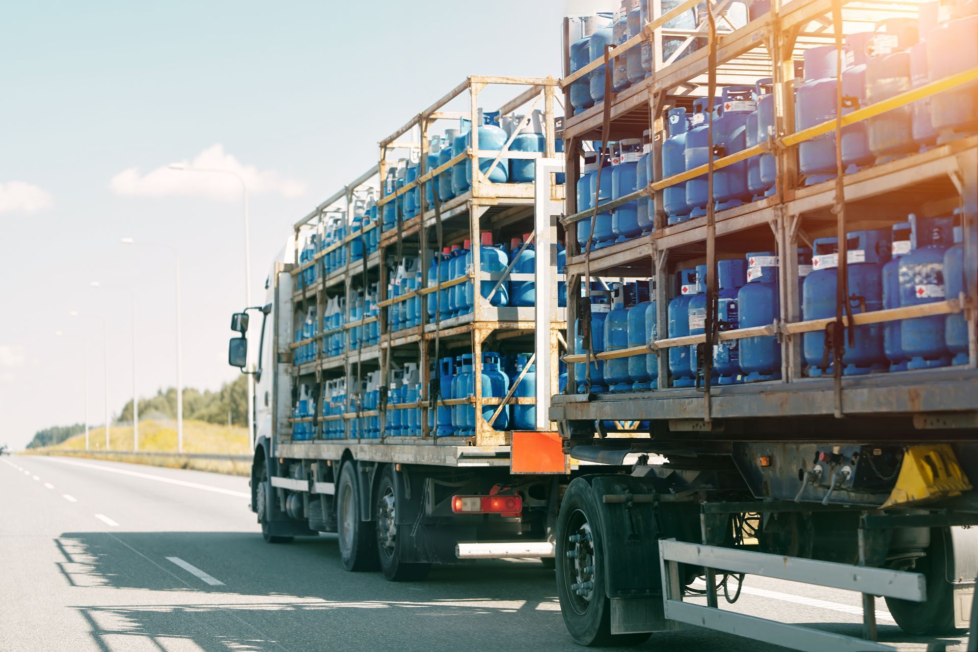 Truck carrying propane tanks on highway. Truck carrying propane tanks on highway.
