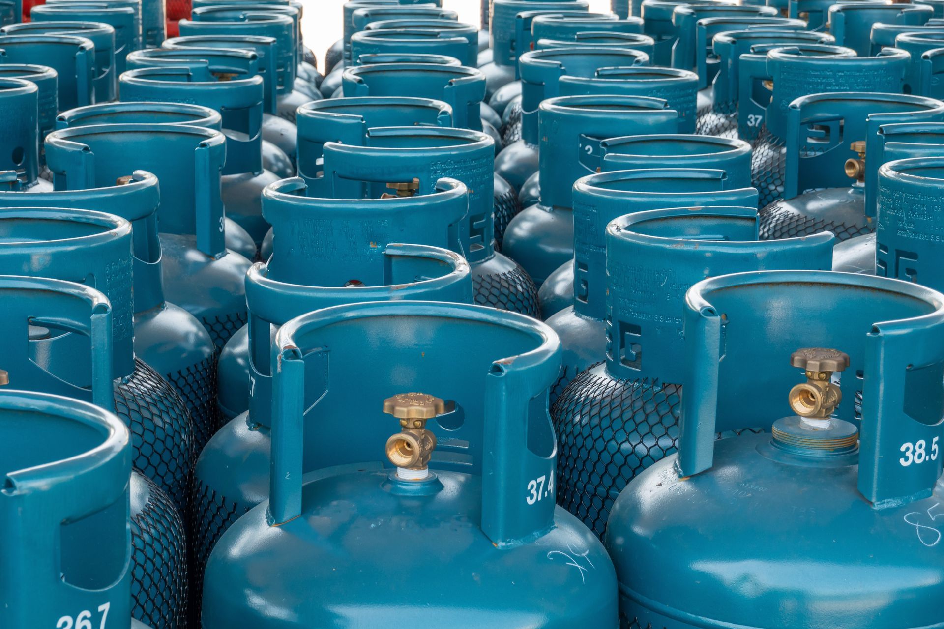 Blue propane delivery tanks lined up in rows. Blue propane delivery tanks lined up in rows.