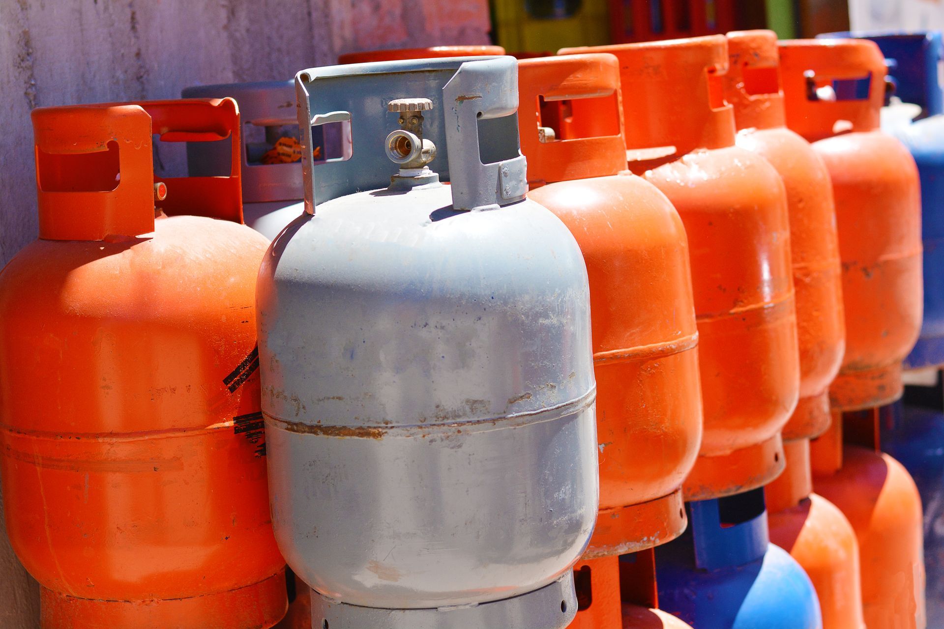 Row of propane gas cylinders in a supplier storage warehouse serving New Braunfels, TX