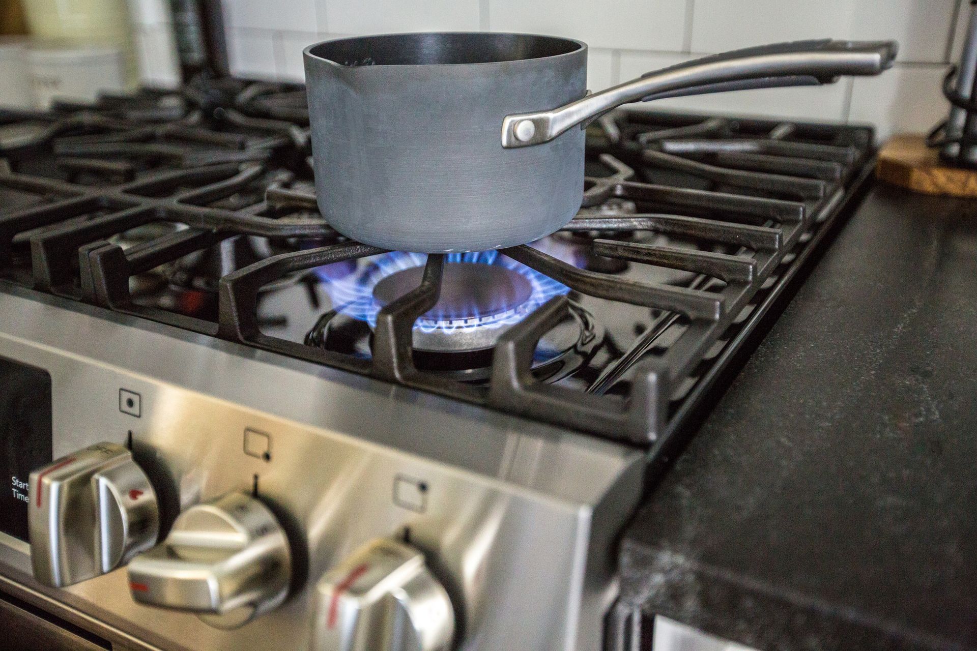 A stainless-steel pot on a gas stove.