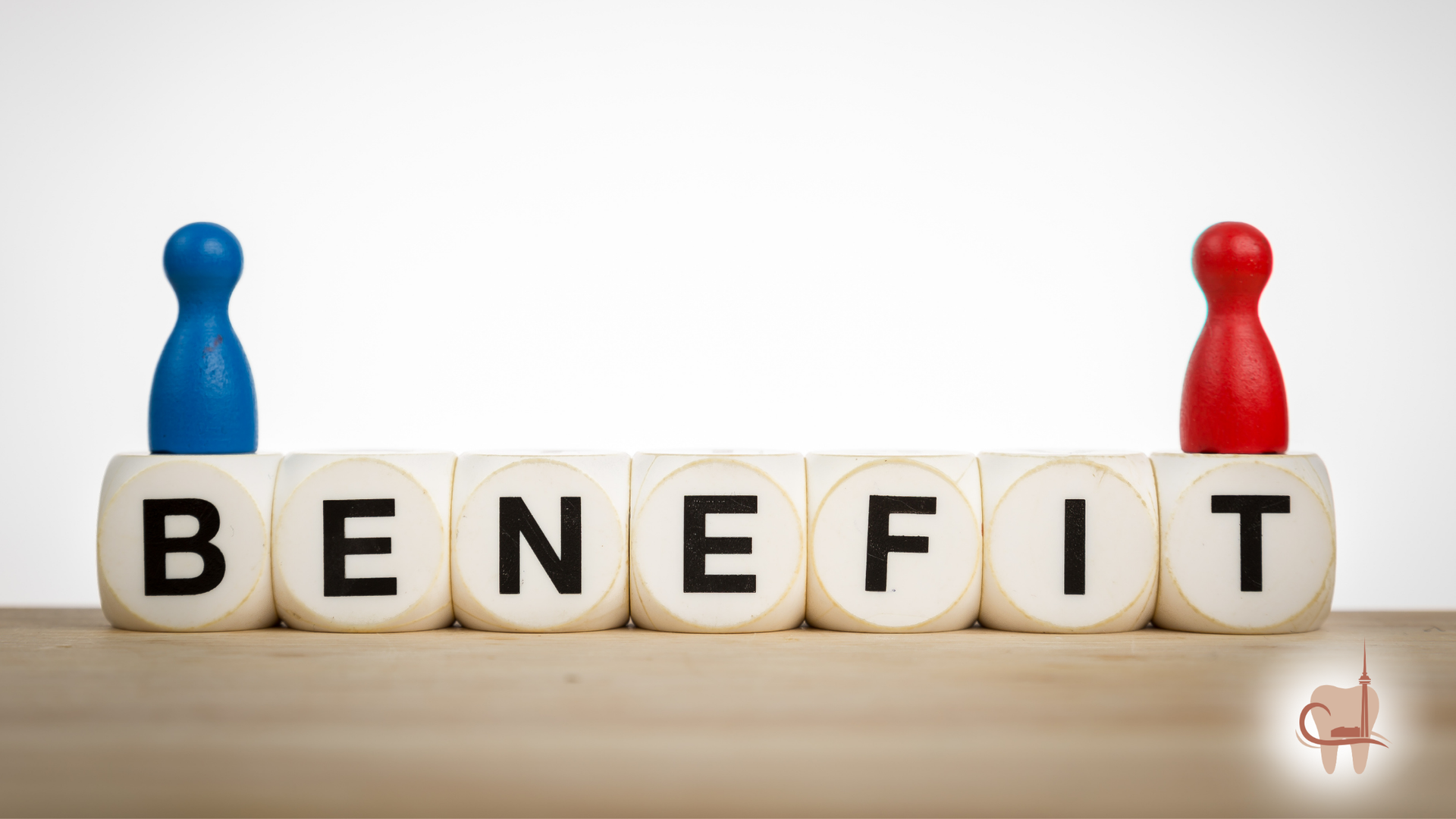Blue and red figurines flanking the word BENEFIT spelled out on blocks.