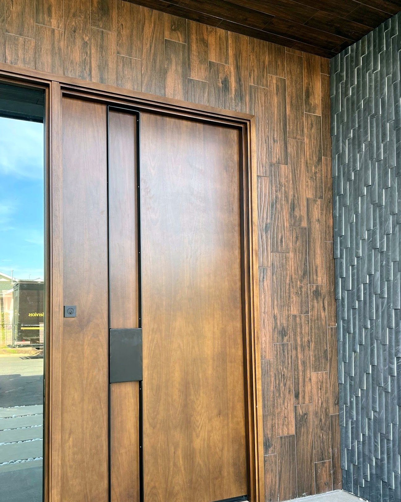 Custom wood and steel pivot entry door