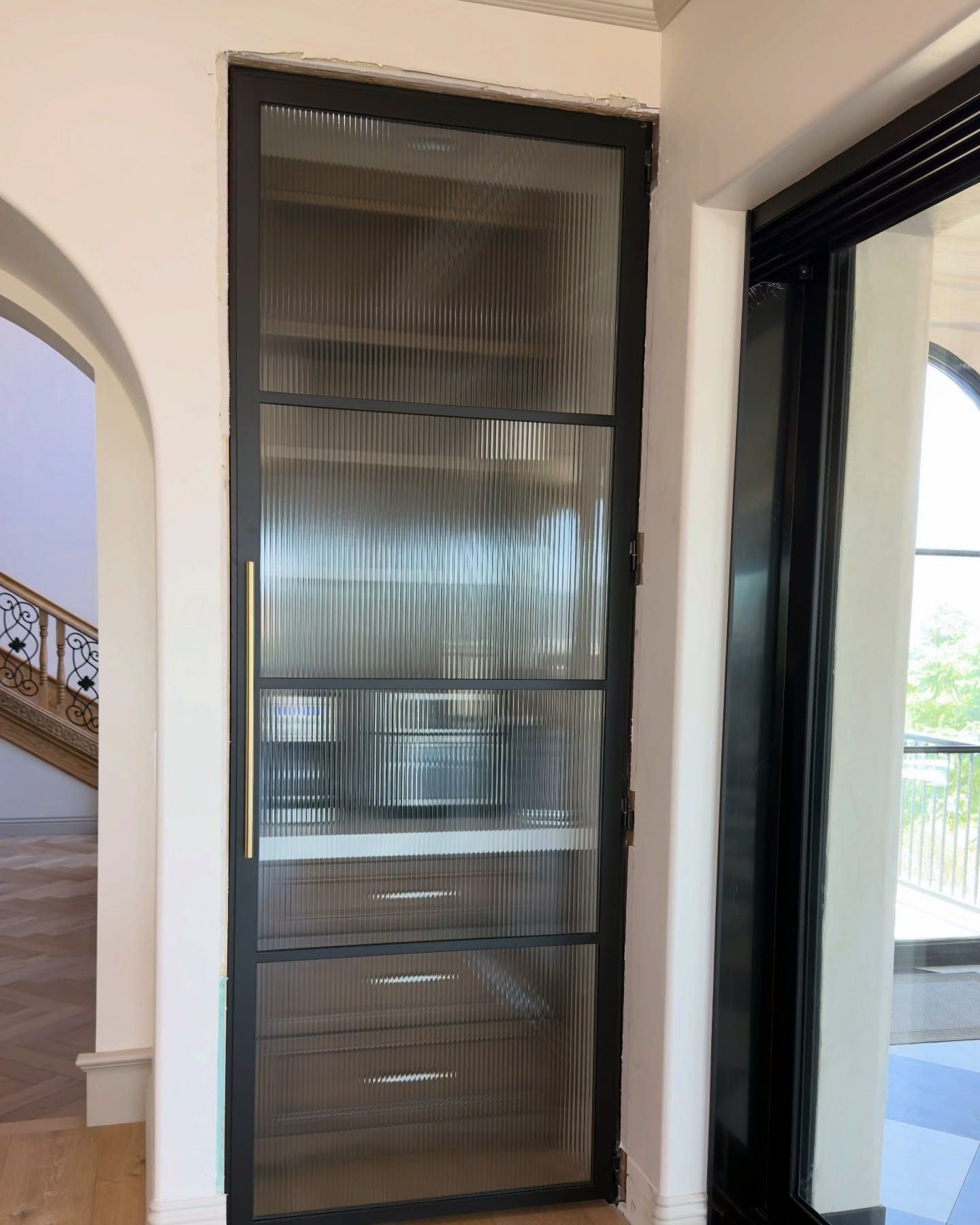 Steel and reeded glass pantry door