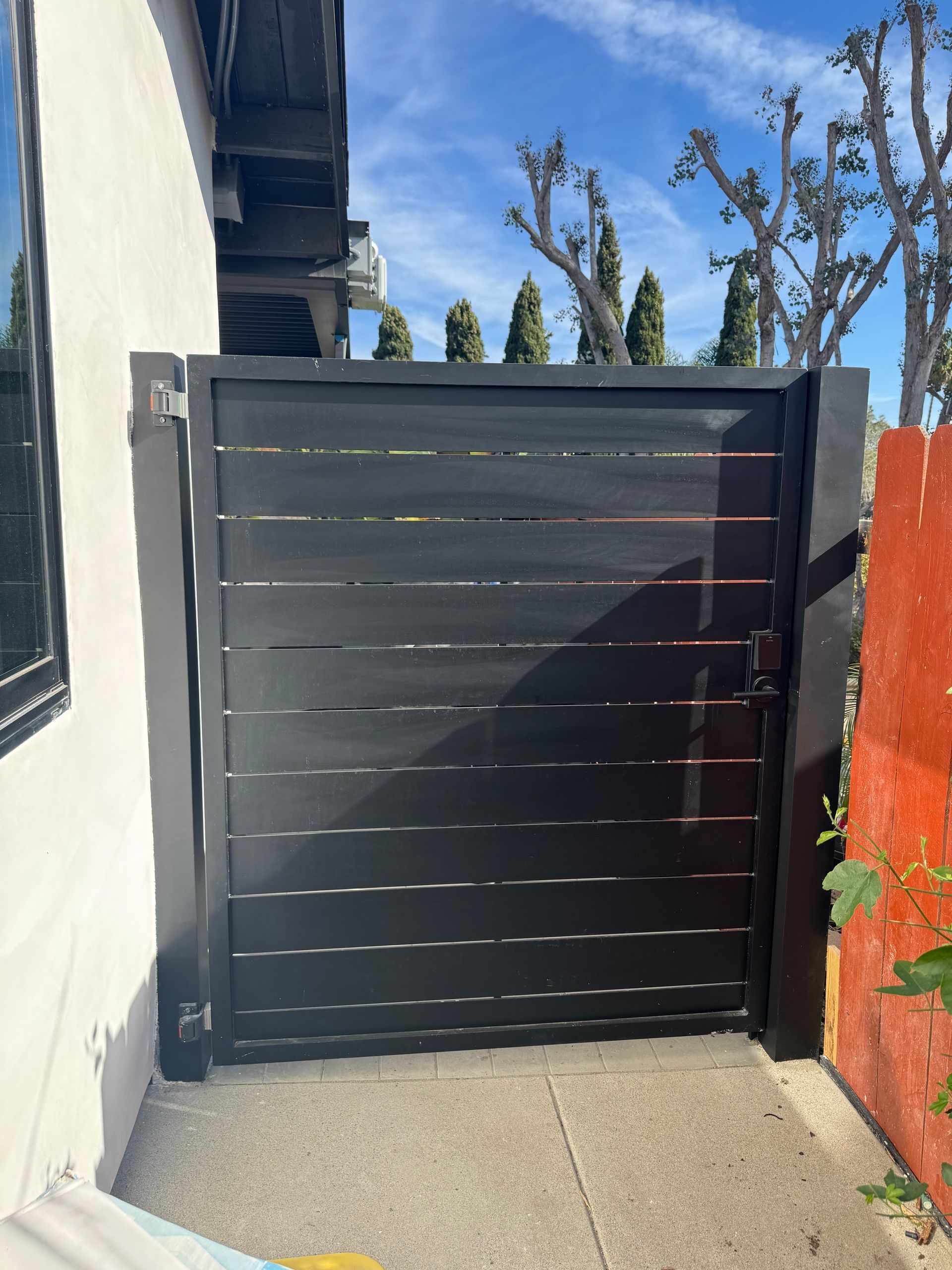 Modern black horizontal slat side gate