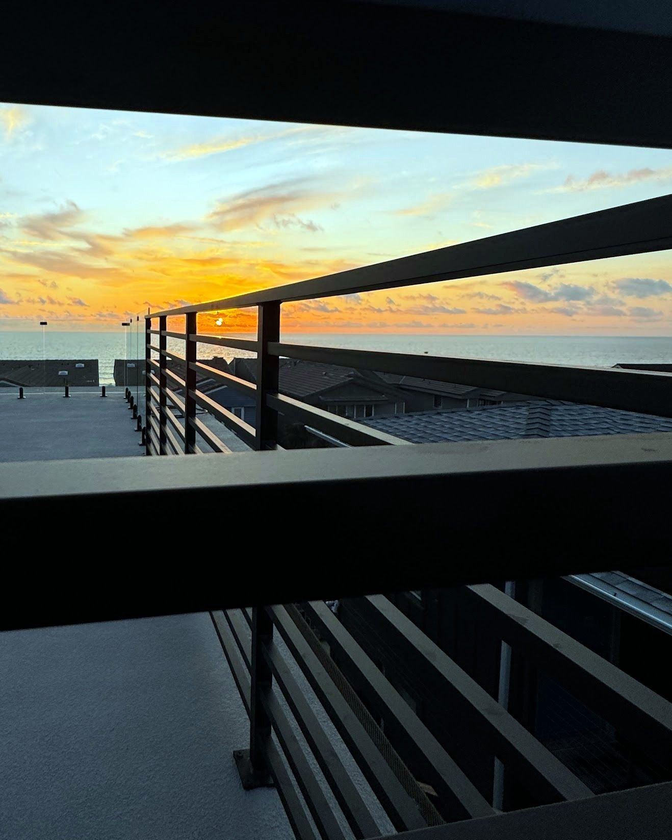 Steel rooftop railing at sunset