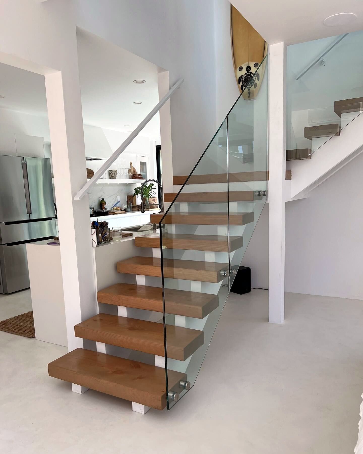 Floating oak staircase with frameless glass railing