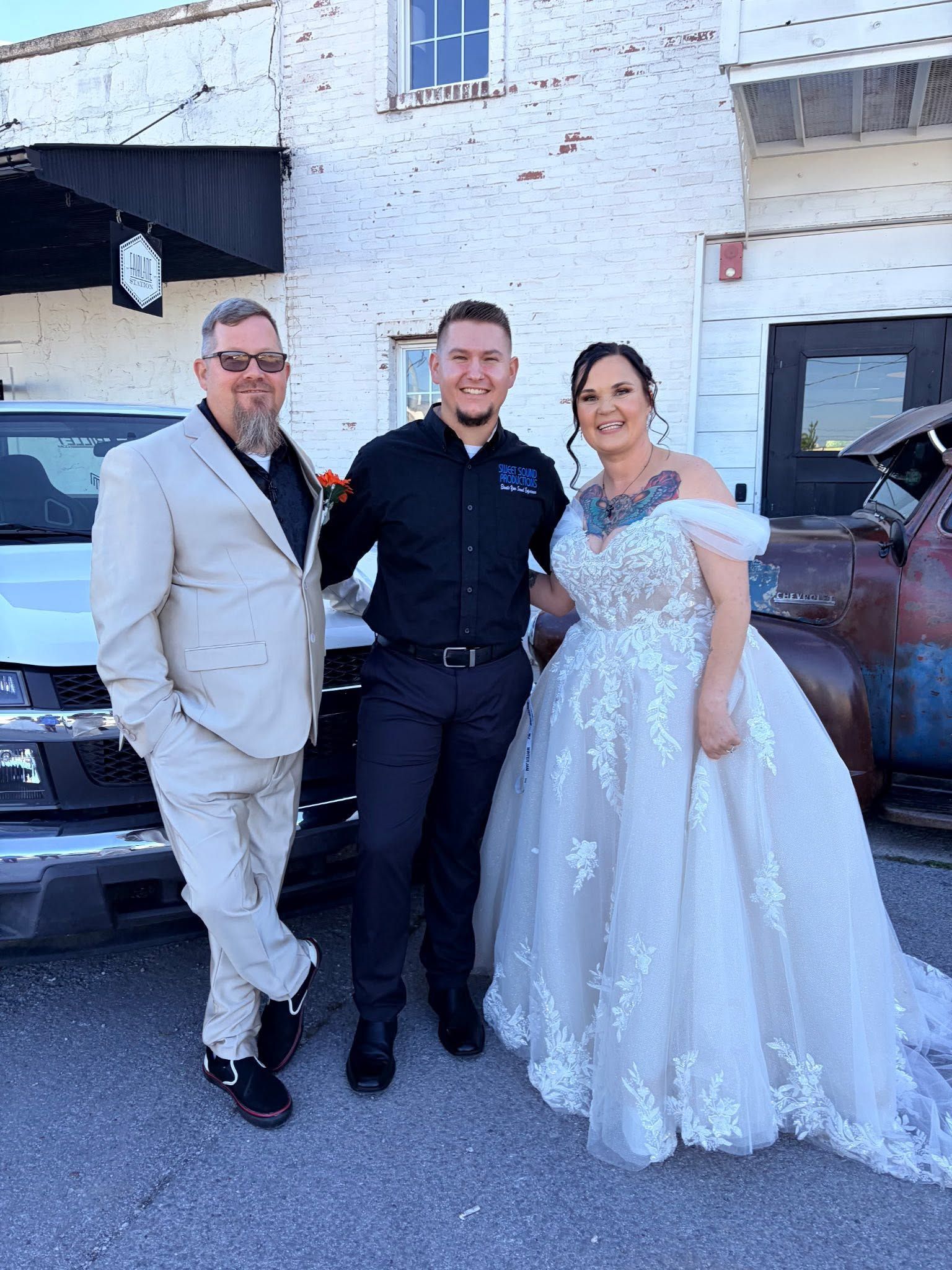 Eric Perdue and wedding couple taking a picture together 