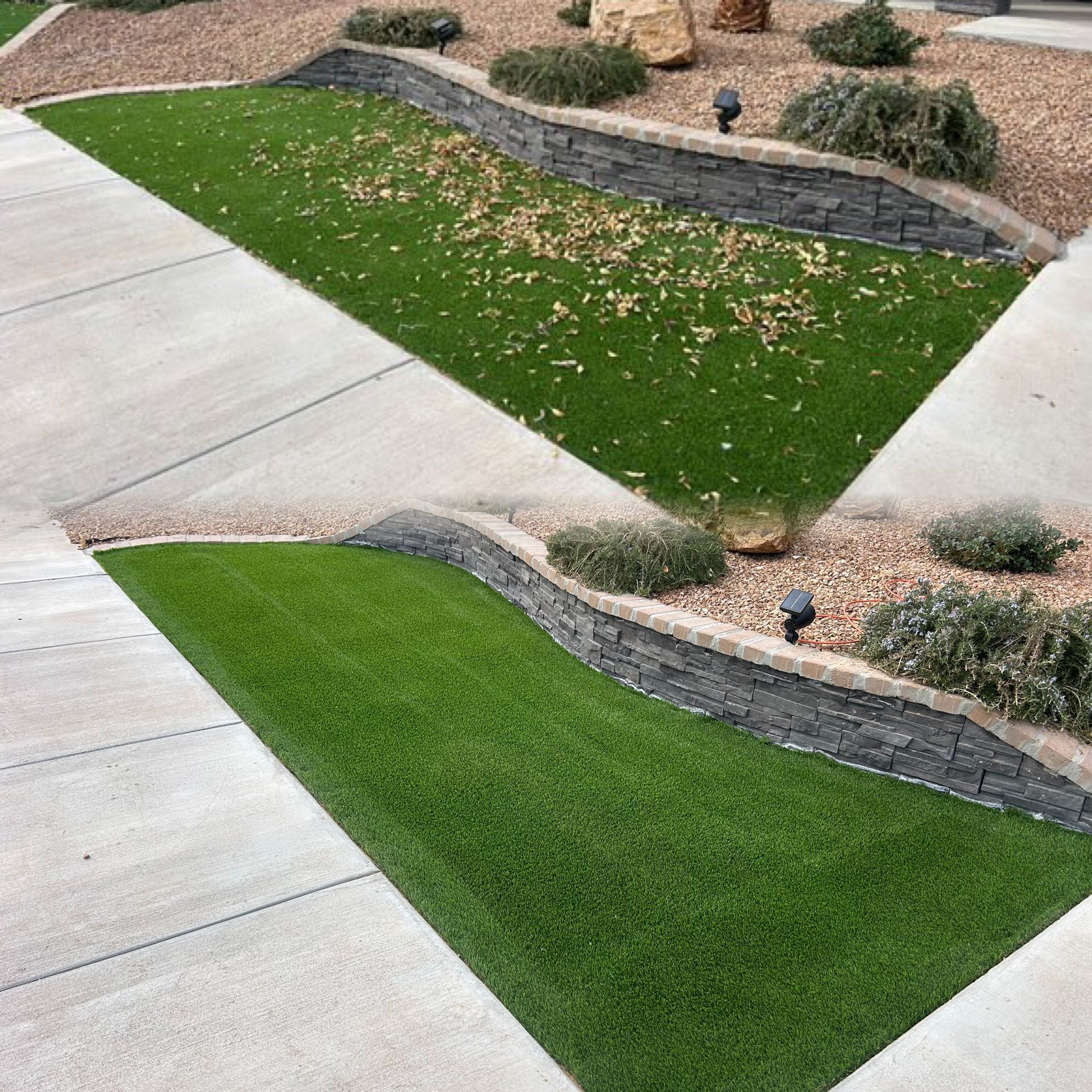 Curved green turf strips between light concrete driveways and tan landscaped beds with small lights.