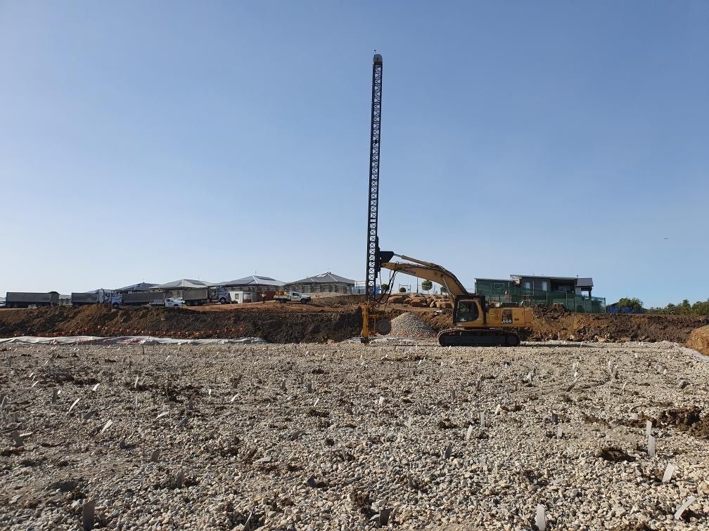 A Bulldozer is Digging a Hole in the Ground — North Coast Drilling & Wicks in Bangalow, NSW