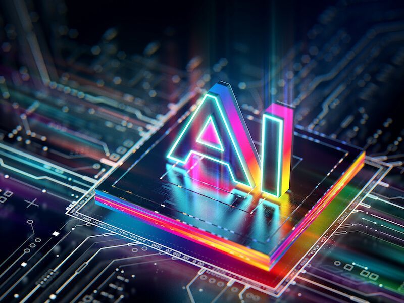 Neon-lit AI letters on a glowing circuit board, symbolizing artificial intelligence technology