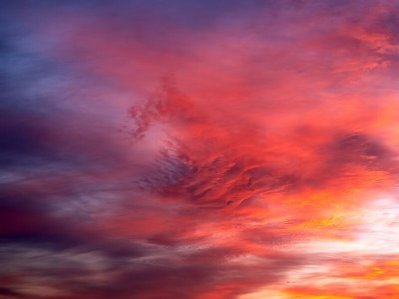 Vibrant red and purple sunset clouds filling the sky
