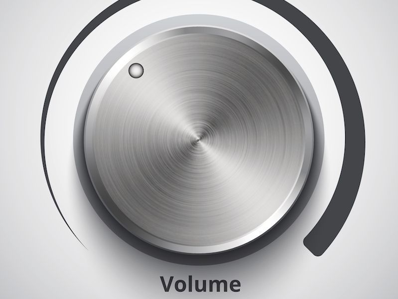 Silver volume knob with a dark arc indicator and the label “Volume” underneath.