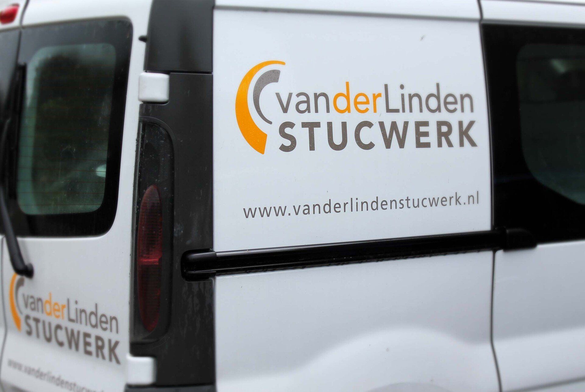 Een witte bestelbus met het logo 
