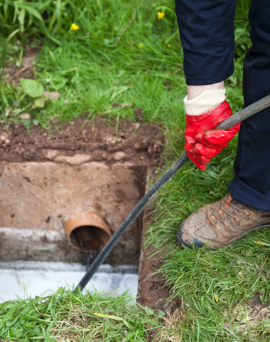 plumber cleaning drain