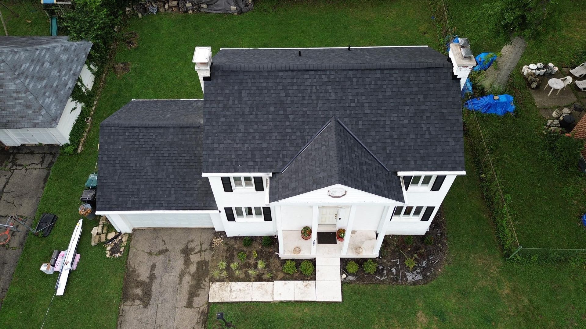 An aerial view of a house with a grey roof.