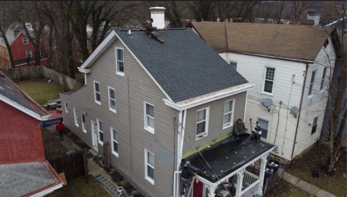An aerial view of a house with a black roof