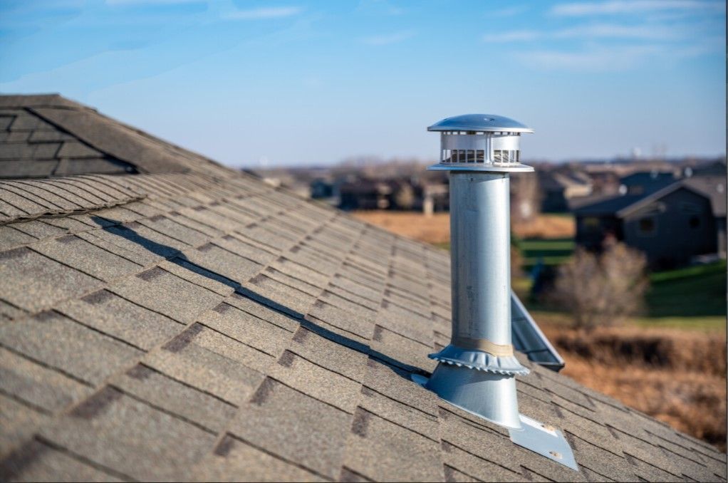 A chimney is sitting on top of a roof.