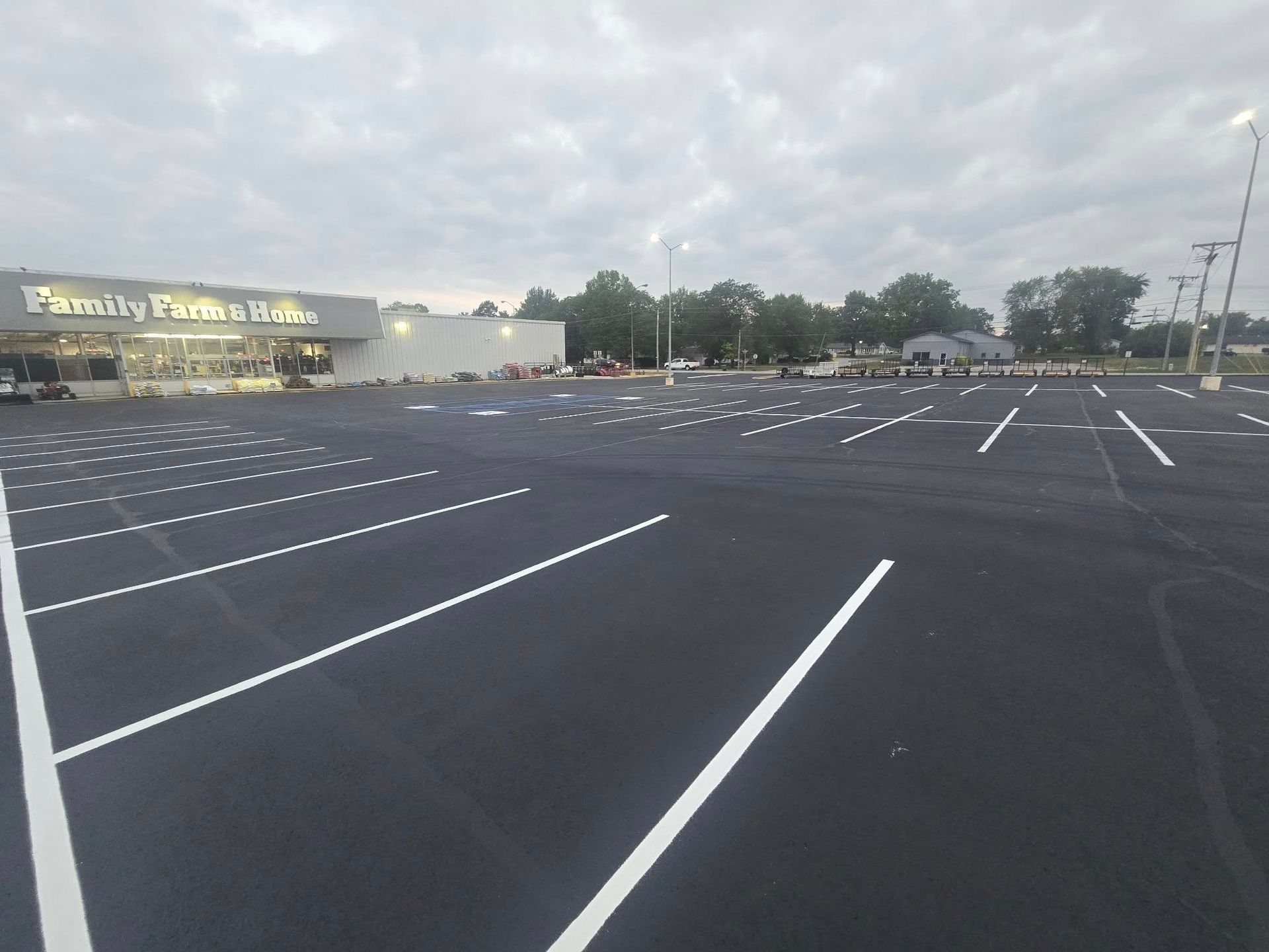 Empty parking lot with fresh white lines outside a store at dusk