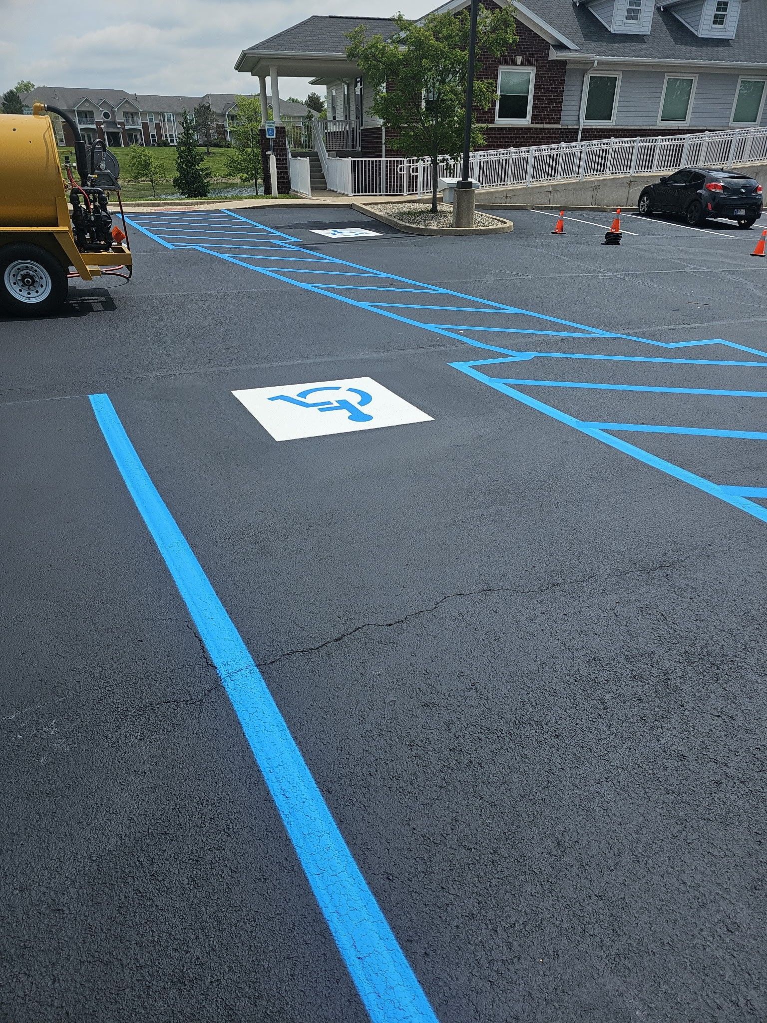 Accessible parking lot with blue handicap markings and reserved spaces near a building entrance