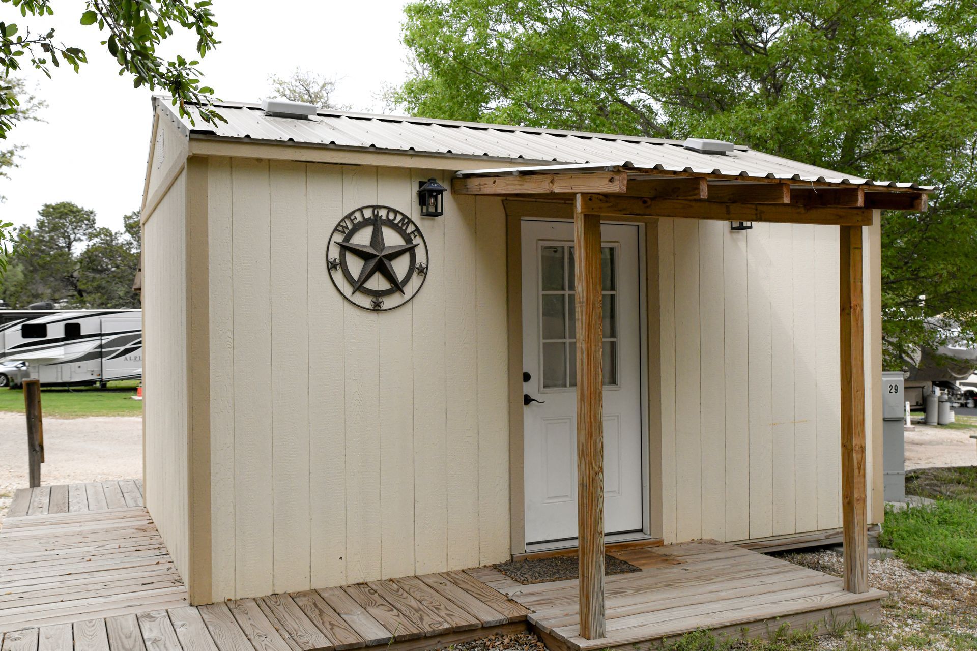 A small white shed with a texas star on the side