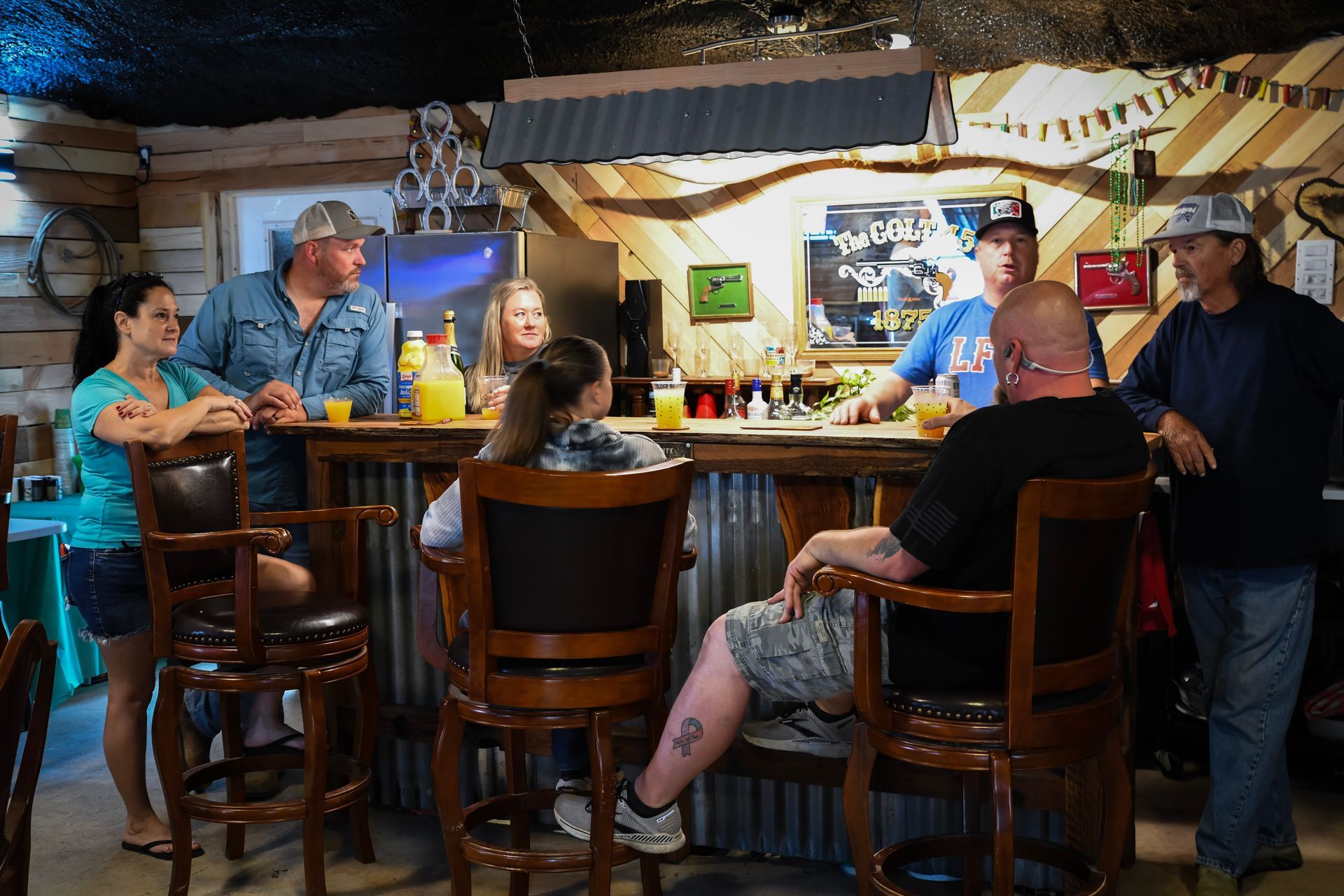 A group of people are sitting at a bar in a restaurant.