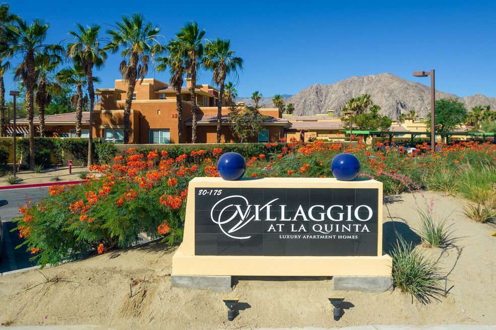 A sign for villaggio at la quinta is in front of a building